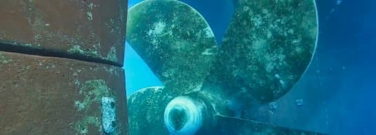 Close underwater view of propeller and hull hardware