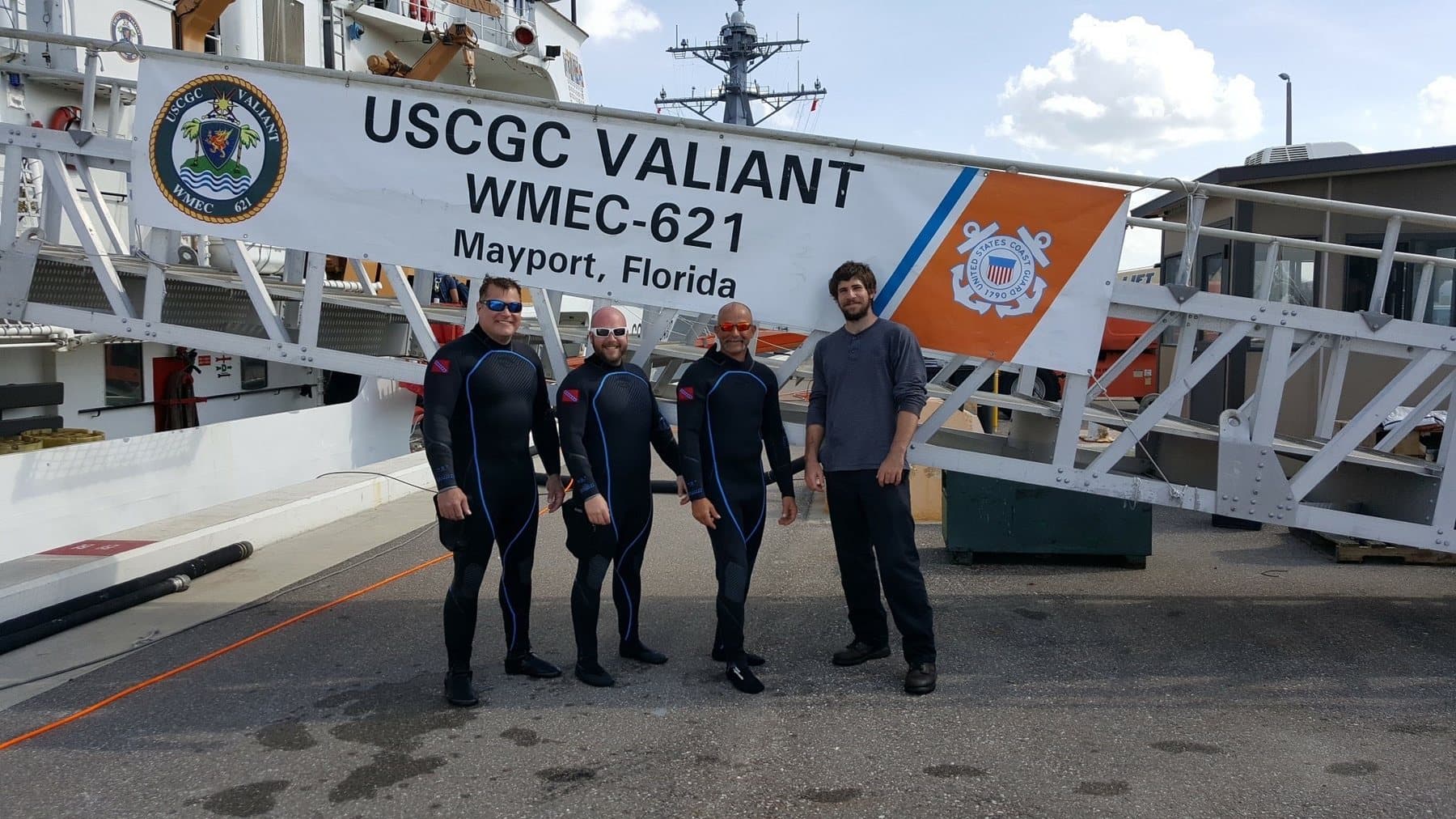 Diving team standing near a Coast Guard vessel