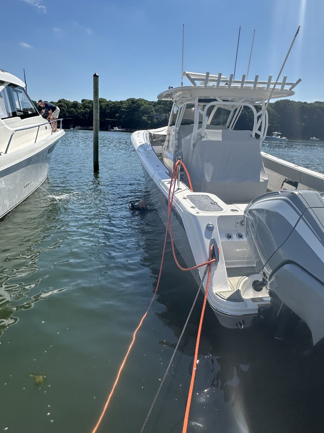Boat positioned in marina slip for underwater service